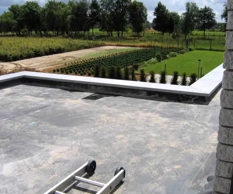 Completed EPDM rubber membrane on a low-slope roof with neat edge metal and properly flashed penetrations