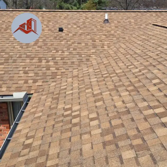 Overhead view of a multicolor brown and orange architectural asphalt shingle roof with two roof vents