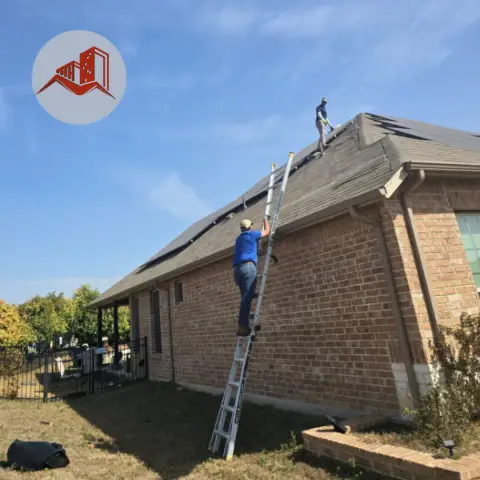 Two roofers on a brick home during a roof inspection