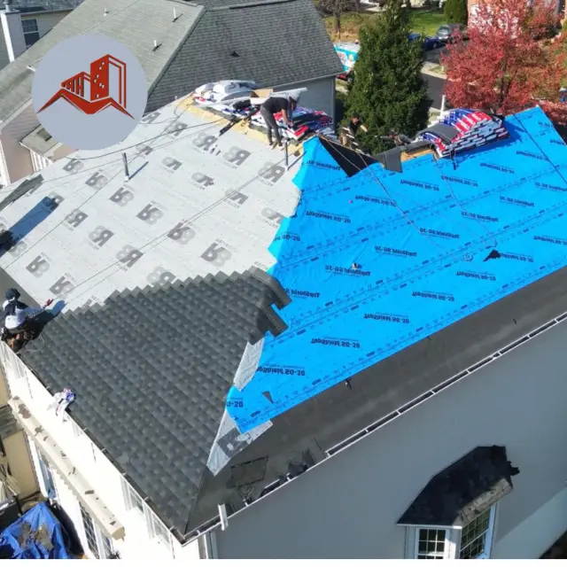 Aerial of a residential roof replacement in progress with synthetic underlayment, blue weather barrier, and bundles of new shingles staged on the deck