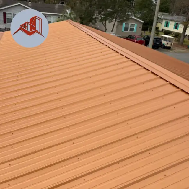 Close-up perspective view of a finished copper-colored ribbed metal roof on a residential home