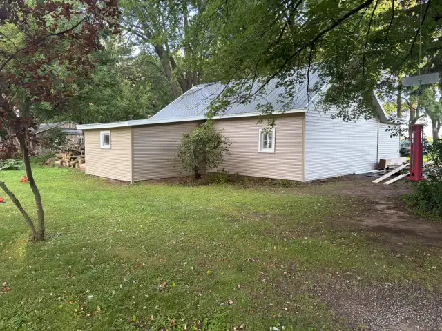 Rear view of a garage after metal roof and siding installation