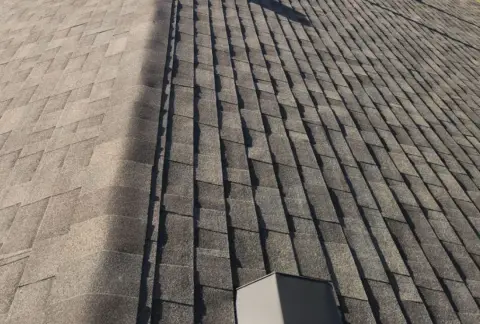 Aerial stock photo of an asphalt shingle roof with box vents and plumbing vent stacks